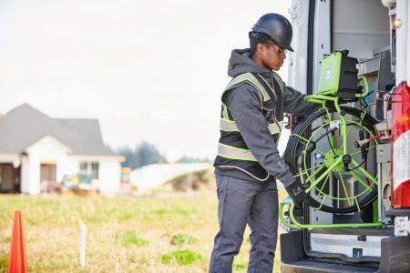 Worker loading a sewer inspection camera.