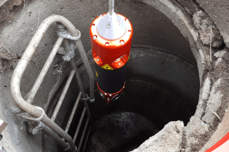 Inspection camera in sewer manhole.